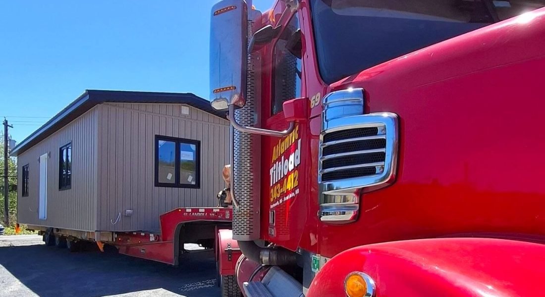 Hatka Home on the back of a red truck on the move